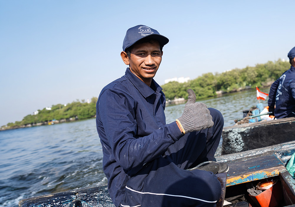 Collector smiling in a boat on the water near Jakarta